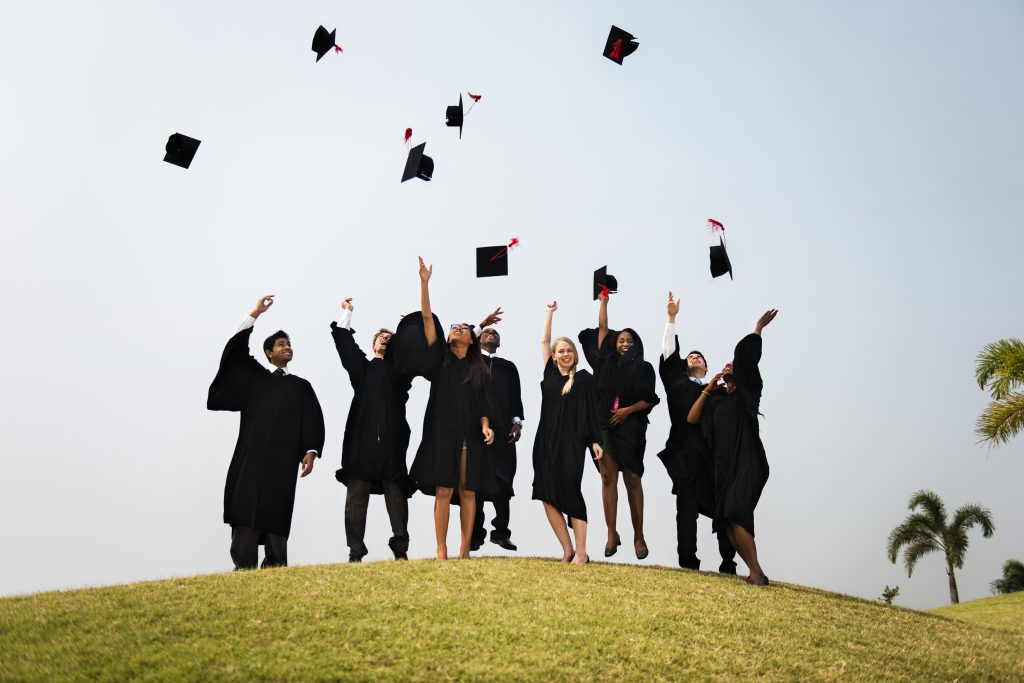 everything grad about grads throwing hats into the air celebrating